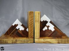 two wooden mountain bookends are shown on a white background