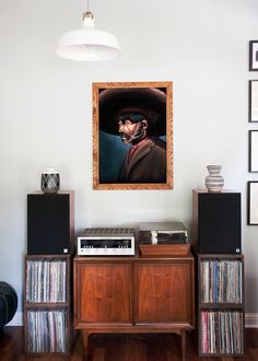 a painting hanging on the wall above a record player