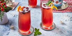 two glasses filled with drinks sitting on top of a table