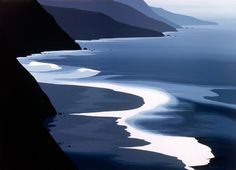 an image of the ocean with mountains in the backgrounnd and water below it