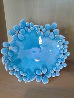 a blue glass bowl with flowers on the bottom is shown in an instagramtion