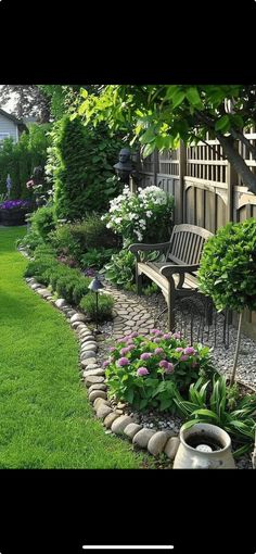 a garden with lots of flowers and plants around it, along with a bench in the middle