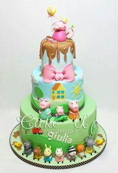 a three tiered cake decorated with animals and farm animals on it's sides