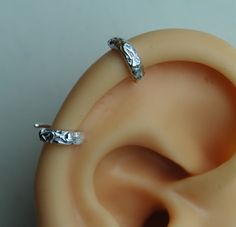 "Textured Pierced Ear-cuff / Helix Cuff Earring / Floral Sterling silver cuff /Small ear cuff / Sterling ear cuff / Scalloped ear cuff / 2 ear cuff so you can wear it anywhere you like.   I can do this shiny or darken it. These are handmade by me and are slightly different sizes. The design is textured with a hint of flowers.  This is a great earring for a man or woman. Measurements- Conch 10mm (3/8\") ID or lobe earrings 1/2\" This listing is for 2 earrings.        Helix 7mm (1/4\") ID   The po Adjustable Metal Hypoallergenic Ear Cuff, Adjustable Hypoallergenic Metal Ear Cuff, Silver Clip-on Metal Cartilage Earrings, White Gold Metal Cartilage Earrings, Elegant Silver Internally Threaded Hoop Earrings, Adjustable Silver Single Clip-on Earring, Silver Clip-on Cartilage Earrings As Gift, Silver Clip-on Cartilage Earrings For Gift, Adjustable Silver Clip-on Cartilage Earrings