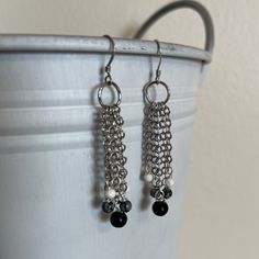 Elegant And Edgy: These Shimmering Earrings Feature A Cascade Of Chains Dripping Into Black Obsidian, Snowflake Obsidian, And Faceted Howlite. Both Strong Grounding Stones, Black Obsidian Increases Our Self-Control While Snowflake Obsidian Keeps Us Calm And Balanced. Howlite Is A Peaceful Gemstone That Brings Patience And Perspective. Earrings Are Made With Sterling Silver Earwires. Approximate Length: 2.25" Note: These Earwires Are Sterling Silver But Can Be Substituted With Silver-Plated Earwi Obsidian Snowflake, Grounding Stones, Black Obsidian Necklace, Chakra Heilung, Root Chakra Healing, Obsidian Necklace, Chakra Racine, Snowflake Obsidian, Black Obsidian