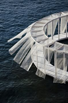 an aerial view of a boat with sheer curtains on it's hulls in the water