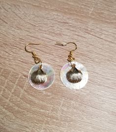 These earrings are made with gold-colored stainless steel and "Mother of Pearl" sea shells.  The studs, hooks, starfish, and clam shells are stainless steel. They are lightweight and perfect for summer vibes. Taxes are included in the price. Pierced Round Pearl Jewelry, Gift Shell-shaped Mother Of Pearl Earrings, Handmade Mother Of Pearl Jewelry For Anniversary, Pearl White Mother Of Pearl Dangle Earrings, Shell Drop Earrings With Matching Set, Shell Drop Earrings Jewelry Set, Nickel-free Shell-shaped Earrings Gift, Handmade Shell-shaped Pearl Earrings For Gifts, Handmade Shell Pearl Earrings For Gift