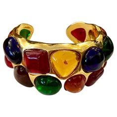 1980s Chanel gold toned cuff bangle adorned with 17 multicolored Gripoix. Stamped 26 made in France. Circumference measures approximately 16 cm Width 3.3 cm Opening 1.6 cm. Comes with dust bag and box. Condition: Minor signs of wear. Generally in very good condition Chanel Vintage Jewelry, 1980s Chanel, Chanel Necklaces, Gold Vintage Jewelry, 1980s Jewelry, Retro Jewelry, Gold Box, Chanel Jewelry, Vintage Bracelet