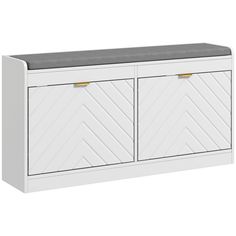 a white cabinet with two doors and a gray seat cushion on top of it,