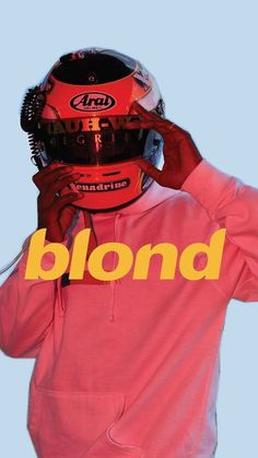 a man wearing a helmet and holding his hands to his face with the word blond written on it