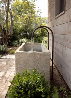 an outdoor water fountain in front of a house