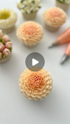 cupcakes decorated with flowers and crochet hooks are shown in this video