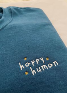 a blue shirt with the words happy human written on it