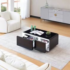 a living room with two white couches and a black coffee table in the middle