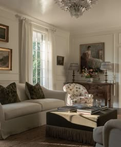 a living room filled with furniture and a chandelier