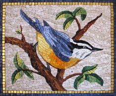 a bird sitting on top of a tree branch covered in lots of blue and yellow tiles