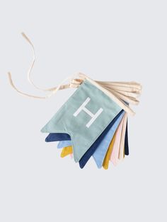 a bunch of towels with the letter h hanging from it's string on a white background