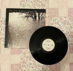 a vinyl record sitting on top of a quilt