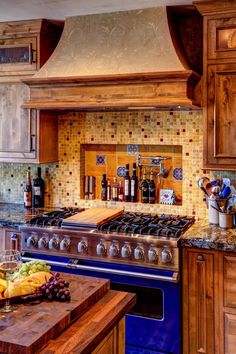 a kitchen with an oven, counter top and fruit on the table in front of it