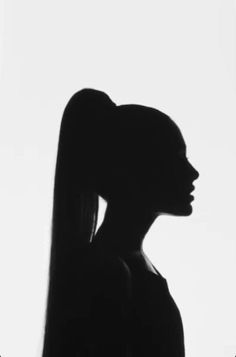 the silhouette of a woman with long hair