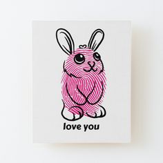 a pink rabbit with the word love you on it's chest is sitting in front of a white background