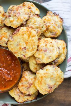 a plate full of biscuits and sauce on a table with a napkin next to it