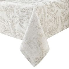 a white table cloth with leaves on it