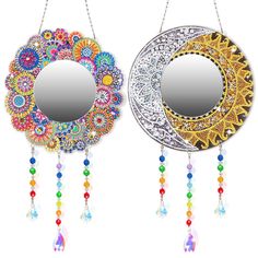 two circular mirrors hanging from chains with beaded decorations on the sides and colorful beads attached to them