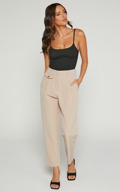 Elevate your wardrobe with the Suri Pant - High Waisted Cropped Tailored Pants in Sand. Perfect for both casual and workwear occasions, these neutral pants are a must-have addition to any fashion-forward closet. The straight leg cut gives a polished and sophisticated look, while the high waist design flatters your figure. The cropped length makes them winter-friendly, perfect for pairing with ankle boots or pumps. Don't miss out on these versatile and stylish pants that will take your outfit gam Chic Tapered Leg Spring Work Pants, Chic Tapered Leg Work Pants For Spring, Chic Tapered Leg Work Pants With Belt Loops, Tapered Leg Pants For Day Out, Chic Spring Tapered Leg Work Pants, Chic Solid Ankle-length Work Pants, Chic Tapered Leg Pants, High Waist Pants With Pockets For Work, Solid Color High-waisted Pants For Business Casual