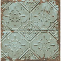 an old tin ceiling tile with decorative designs