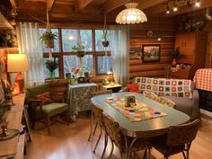 a living room filled with furniture next to a window covered in plants and potted plants