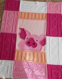 a crocheted blanket with a pig on it