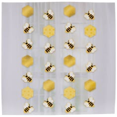 bees and honeycombs are hanging on the wall in front of a white curtain