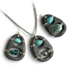 three pieces of jewelry are shown on a white surface, including two pendants with turquoise beads