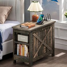 a bedroom with a bed, nightstand and lamp on it in front of a window