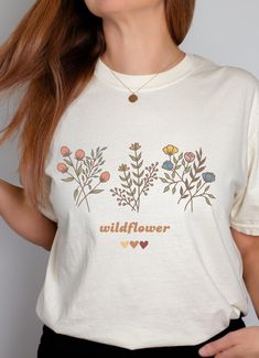 Wildflowers Retro T-shirt, Minimalist Style Tee, Womens Floral Shirt This shirt is made from 100% with ring-spun cotton that is ethically grown and harvested. The soft-washed, garment-dyed fabric brings extra coziness to your wardrobe while the relaxed fit makes it an excellent daily choice. The double-needle stitching throughout the tee makes it highly durable while the lack of side-seams helps the shirt retain its tubular shape.  The pre-shrunk fabric ensures a consistently great fit and size Retro T Shirt, Retro Tshirt, Dyed Fabric, Floral Shirt, Minimalist Style, Fashion Tees, How To Take Photos, Minimalist Fashion, San Jose