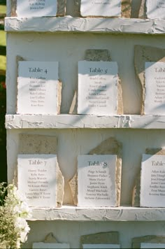 there are many plaques on the wall with names and numbers in each one, including tables