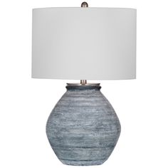 a lamp that is on top of a table with a white lampshade over it