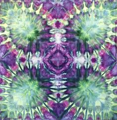 an image of a tie - dyed fabric with flowers in the middle and green, purple, and yellow colors