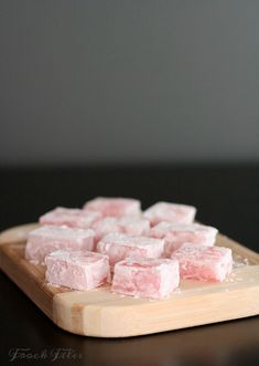 pink marshmallows on a wooden cutting board