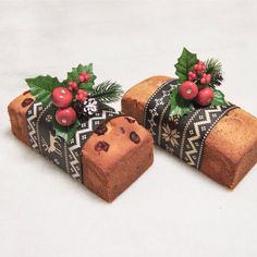 two pieces of bread with holly and berries on them