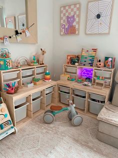 a child's playroom with toys and storage bins