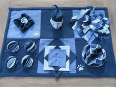 the table is covered with blue and white paper decorations, such as napkins, cups, and plates