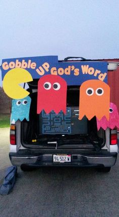 the back of a van decorated with paper cutouts and googly - up god's word