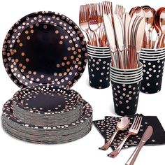 black and white polka dot paper cups with silverware in them, along with napkins and utensils