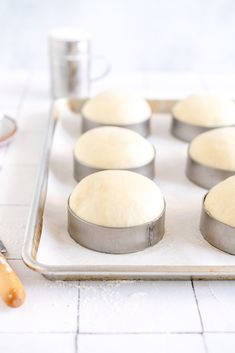 doughnuts sitting on top of a metal tray next to a cupcake tin