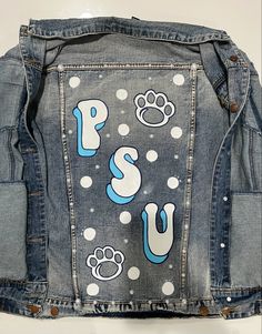 a denim jacket with dog paw prints on it