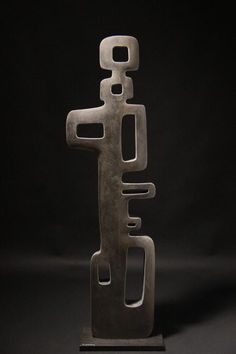 an abstract metal sculpture on a black background