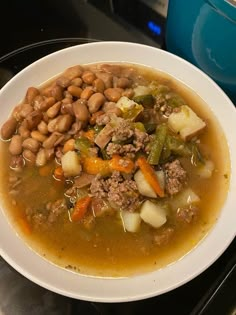 a white bowl filled with soup and beans