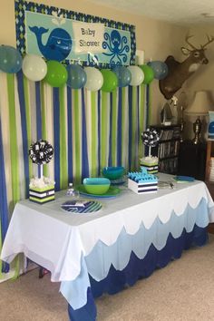 a baby shower party with blue, green and white decorations